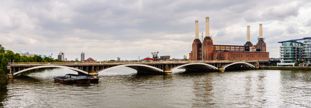 Panoramic view of a rail bridge over the River Thames and Battersea Power Station in London, UKの写真素材