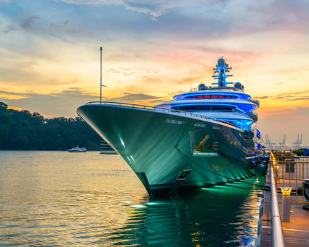 Docked green yacht at sunset in Singaporeのeditorial素材