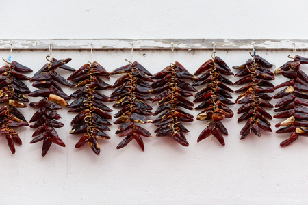Strings of PDO Espelette chilli peppers drying, Franceの写真素材