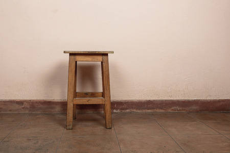 Rustic wooden stool, pink wall backgroundの写真素材