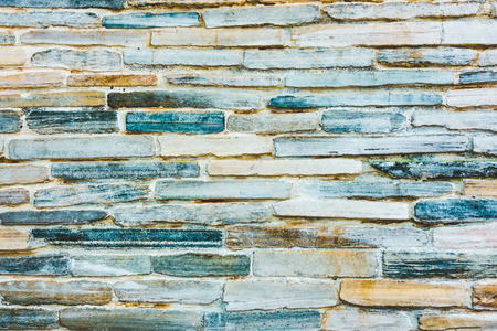 Stone wall texture with blue and orange hueの写真素材