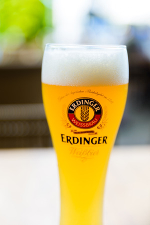 SINGAPORE CITY, SINGAPORE - CIRCA JANUARY 2016: A glass of Erdinger beer at a restaurant terrace.のeditorial素材
