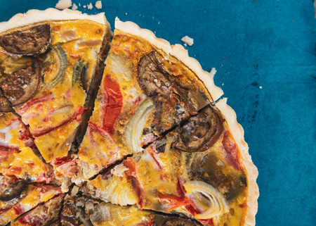 Sliced quiche on blue backgroundの写真素材