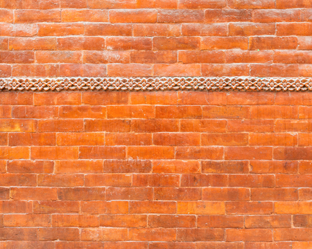 Glazed brick wall texture with a frieze in the top thirdの写真素材