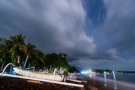 Traditional fishing boats on Amed beach at night in Bali, Indonesia. Long exposure photography...