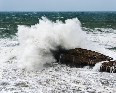 Wave crashing on rock by a stormy day on the Atlantic coast in southwest Franceの写真素材