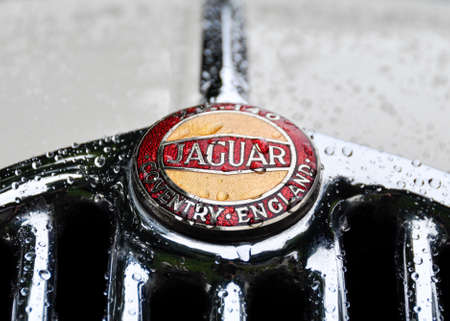 LONDON, UK - CIRCA SEPTEMBER 2011: Jaguar logo on Jaguar XK140 radiator grill. Raindrops on the grill and bodywork.のeditorial素材