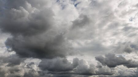 Dramatic dark cloudy sky, stormy or rainy weather natural backgroundの写真素材