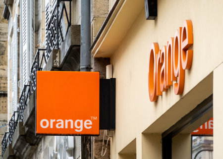 BAYONNE, FRANCE - CIRCA DECEMBER 2020: Orange sign at shop entrance in the town center.のeditorial素材
