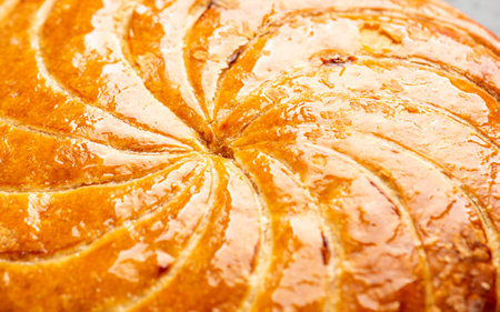 Detail shot of Epiphany cake or galette des rois in French shows the shiny texture of the puff pastryの写真素材