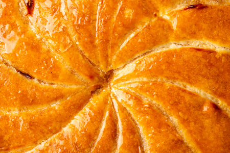 Detail shot of Epiphany cake or galette des rois in French shows the shiny texture of the puff pastryの写真素材
