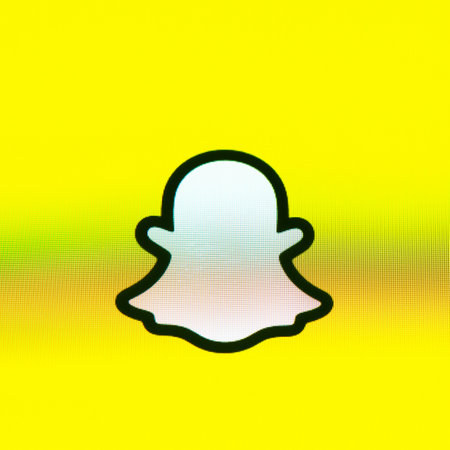 BAYONNE, FRANCE - CIRCA JANUARY 2021: Snapchat ghost logo on yellow background, Apple iPhone screen....