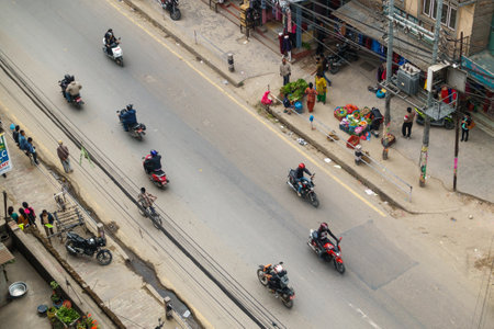 KATHMANDU, NEPAL - CIRCA APRIL 2016: Street aerial view with scooters, motorbikes vegetable vendors.のeditorial素材