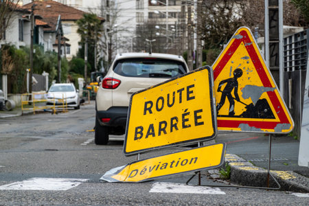 Road closed, diversion and road work signs in French townの写真素材
