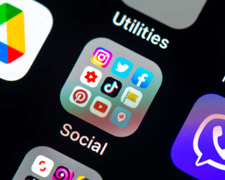 BAYONNE, FRANCE - CIRCA FEBRUARY 2021: Social media app icons in folder on iPhone screen.のeditorial素材