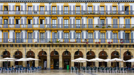 SAN SEBASTIAN, SPAIN - CIRCA SEPTEMBER 2013: Building facade, arcades and cafe terrace on Plaza de la Constitucionのeditorial素材