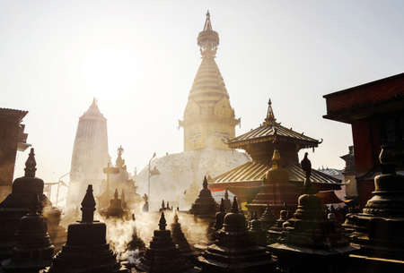 Swayambhunath stupa in Kathmandu, Nepal. Backlit smoke in the morning light.の写真素材