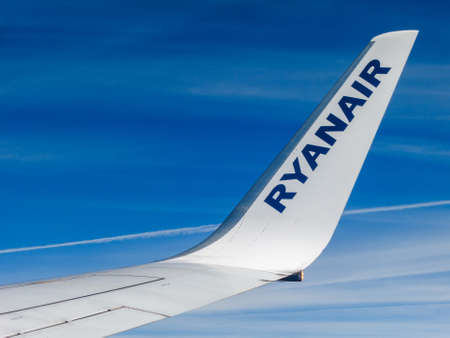 IN FLIGHT - CIRCA SEPTEMBER 2013: Ryanair airplane wing detail. Ryanair s an Irish low-cost airline founded in 1984.のeditorial素材