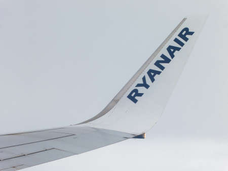 IN FLIGHT - CIRCA SEPTEMBER 2013: Ryanair airplane wing detail. Ryanair s an Irish low-cost airline...
