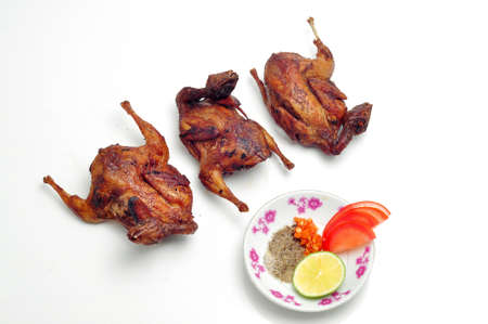 Vietnamese grilled quail on a white backgroundの写真素材