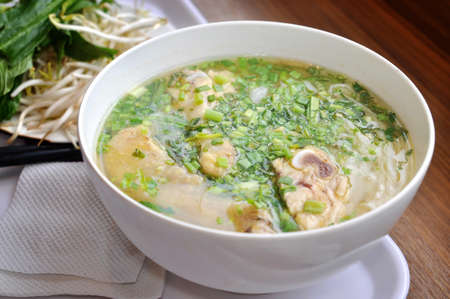 Pho or Vietnamese rice vermicelli noodle with beef or chicken on the table