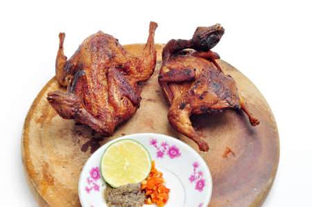 Vietnamese grilled quail on a white backgroundの写真素材