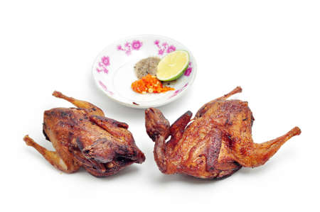 Vietnamese grilled quail on a white backgroundの写真素材