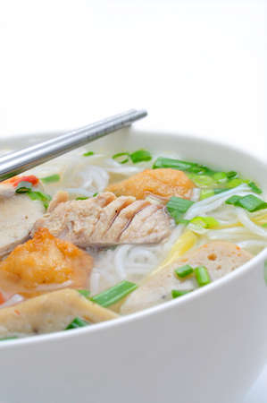 Bun cha ca or Vietnamese rice vermicelli with grilled fish and herbs on a white backgroundの写真素材