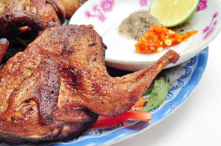 Vietnamese grilled quail on a white backgroundの写真素材