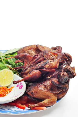 Vietnamese grilled quail on a white backgroundの写真素材