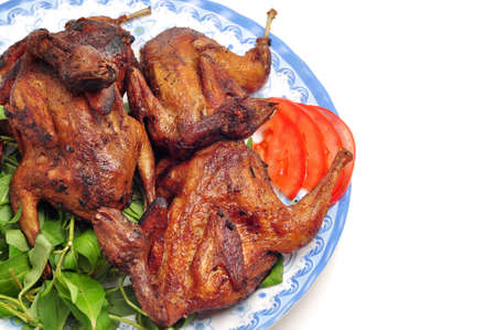 Vietnamese grilled quail on a white backgroundの写真素材