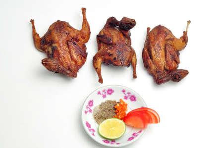 Vietnamese grilled quail on a white backgroundの写真素材