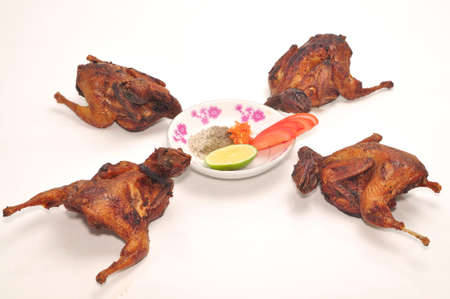 Vietnamese grilled quail on a white backgroundの写真素材