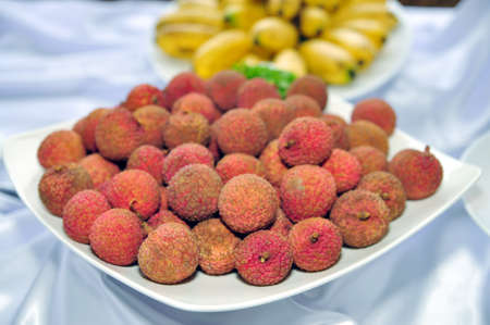Litchi fruit on a white dishの写真素材