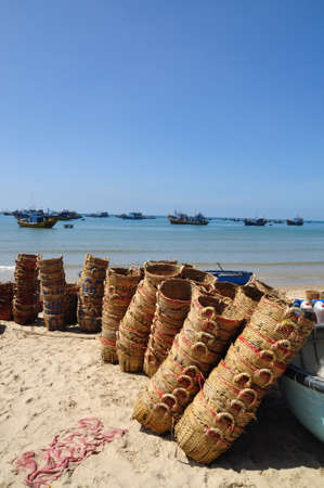 LAGI, VIETNAM - FEBRUARY 26, 2012: Baskets used for transporting fishes from the boat to the truck are on the beach after workingのeditorial素材