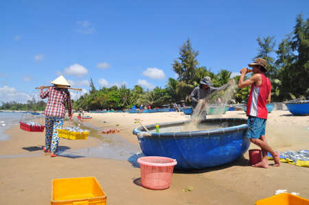 LAGI, VIETNAM - FEBRUARY 26, 2012: Local fishermen are preparing their fishing nets for a new working day in the Lagi beachのeditorial素材