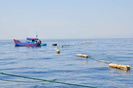 NHA TRANG, VIETNAM - MAY 4, 2012: Fishing boats are preparing to trawl in the sea of Nha Trang bay...