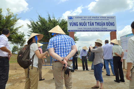 DONG THAP, VIETNAM - MARCH 1, 2013: International reporters and journalists are about to enter a pangasius catfish farm in the mekong delta of Vietnamのeditorial素材