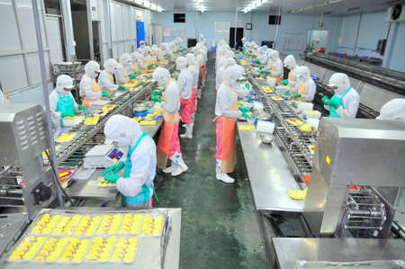 HO CHI MINH CITY, VIETNAM - OCTOBER 3, 2011: Workers are working hard on a production line in a seafood factory in Ho Chi Minh city, Vietnamのeditorial素材