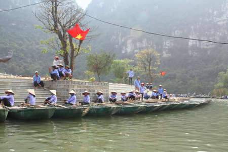 NINH BINH, VIETNAM - MARCH 29, 2010: Ferrymen are waiting for tourists to visit the Trang An Eco-Tourism Complex, a complex beauty - landscapes called as an outdoor geological museumのeditorial素材