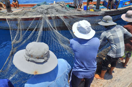 NHA TRANG, VIETNAM - MAY 5, 2012: Fishermen are trawling for tuna fish in the sea of Nha Trang bay...