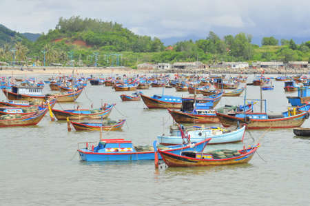 NHA TRANG, VIETNAM - OCTOBER 5, 2011: Fishing boats are mooring in a seaport of Nha Trangのeditorial素材