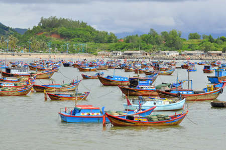 NHA TRANG, VIETNAM - OCTOBER 5, 2011: Fishing boats are mooring in a seaport of Nha Trangのeditorial素材