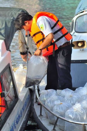 HO CHI MINH CITY, VIETNAM - APRIL 24, 2015: Fishes are kept in plastic bags preparing to be released in the Saigon river in the National Fisheries day in Vietnamのeditorial素材