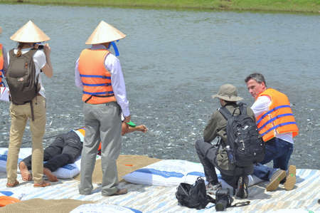 DONG THAP, VIETNAM - MARCH 1, 2013: International reporters and journalists are visiting a pangasius catfish farm in the mekong delta of Vietnamのeditorial素材