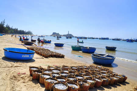 LAGI, VIETNAM - FEBRUARY 26, 2012: Fisheries are located on the beach in many baskets waiting for uploading onto the truck to the processing plantのeditorial素材