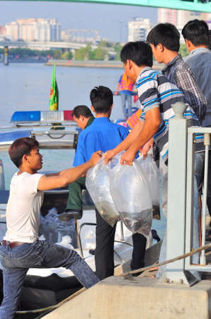 HO CHI MINH CITY, VIETNAM - APRIL 24, 2015: Fishes are kept in plastic bags preparing to be released in the Saigon river in the National Fisheries day in Vietnamのeditorial素材