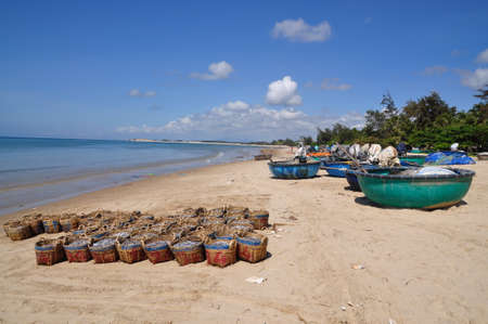 LAGI, VIETNAM - FEBRUARY 26, 2012: Fisheries are located on the beach in many baskets waiting for uploading onto the truck to the processing plantのeditorial素材