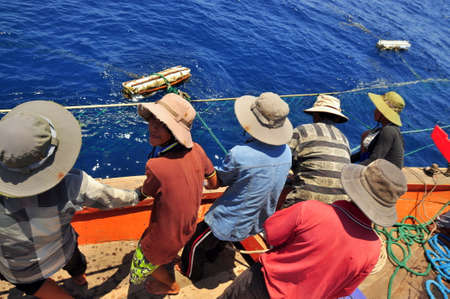 NHA TRANG, VIETNAM - MAY 5, 2012: Fishermen are catching tuna with a trawl net.のeditorial素材