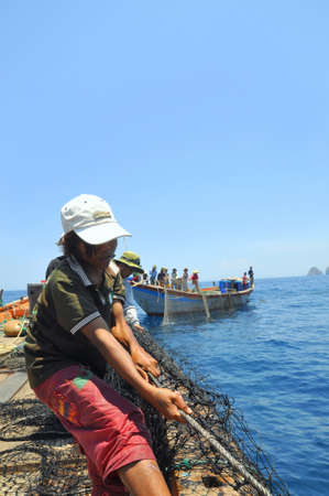 NHA TRANG, VIETNAM - MAY 5, 2012: Fishermen are trawling for tuna fish in the sea of Nha Trang bay in Vietnamのeditorial素材